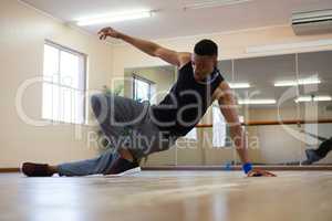 Full length of male dancer practicing on floor