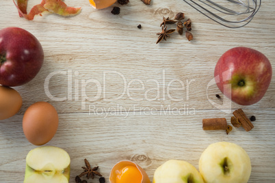 Overhead view of apples and spices with egg