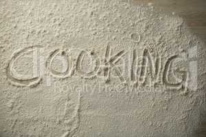 High angle view of cooking text on flour