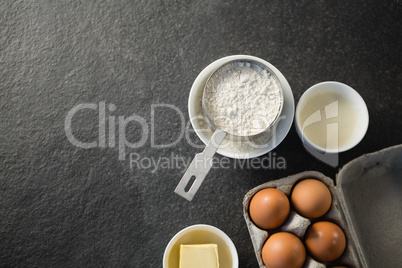 Directly above shot of flour and egg carton
