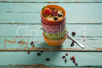 Bowls of wheaties cereal with fruits on wooden table