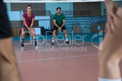 Focused players practicing volleyball