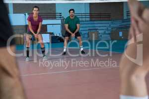 Focused players practicing volleyball