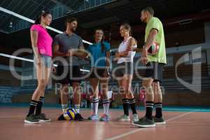 Full length of volleyball players discussing