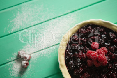 Raspberries and blackberries on tart in baking pan