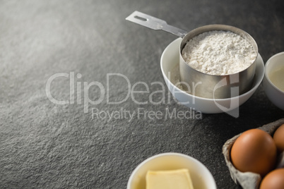 Close up of flour in measuring cup by ingredients