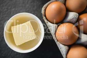 Close up of butter in bowl by egg carton