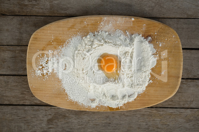 Directly above shot of egg yolk in flour on cutting board
