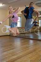 Portrait of dancers jumping at studio