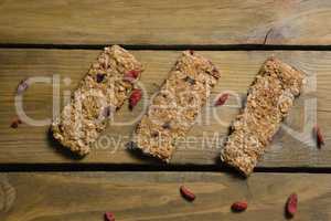 Three granola bars arranged on wooden table