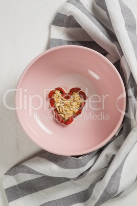 Dried fruits forming heart shape in plate