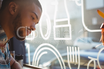 Close-up of man looking down in cafe