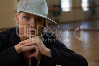 Portrait of female dancer wearing cap in studio