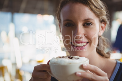 Portrait of beautiful woman having coffee