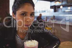 Portrait of woman drinking milkshake