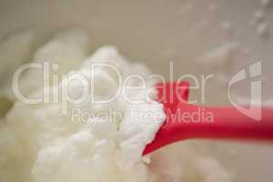 Close up of red spatula and whipped cream