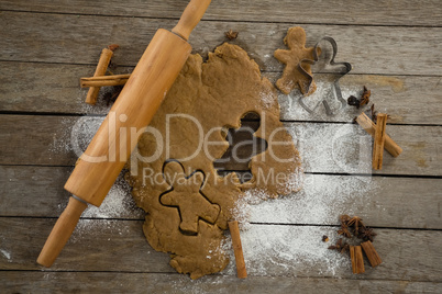 Overhead view of dough with pastry cutter and rolling pin