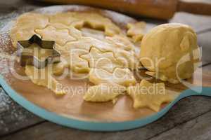 Close up of dough on cutting board with star shape cutter