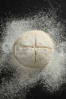 Overhead view of flour on unbaked bun