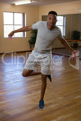 Full length portrait of dancer rehearsing in studio