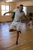 Full length portrait of dancer rehearsing in studio