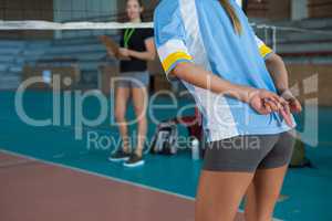 Mid section of volleyball player gesturing while playing