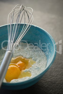 High angle view of egg and flour in bowl