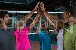 Volleyball players giving high-five at court