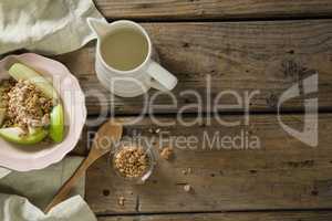 Plate of breakfast cereals with fruits and milk