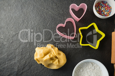 Overhead view of moulds with candies in bowl and dough