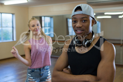 Portrait of male dancer with friend standing in studio