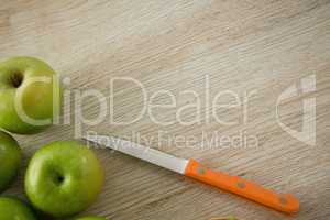 Overhead view of granny smith apple by kitchen knife