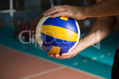 Cropped hands of player holding volleyball
