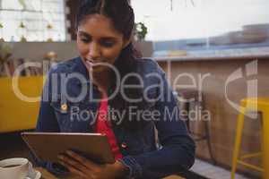 Woman using tablet in cafe