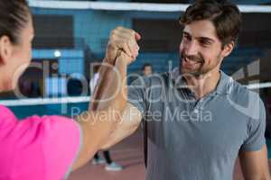 Determined volleyball player holding hand with teammate