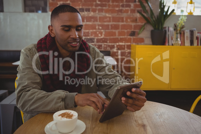 Man using tablet at cafe