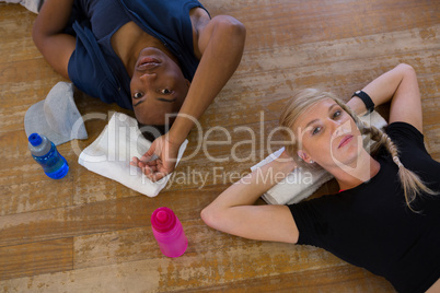 Portrait of dancers relaxing on floor in studio