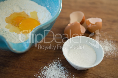 High angle view of egg and flour