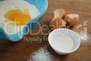 High angle view of egg and flour