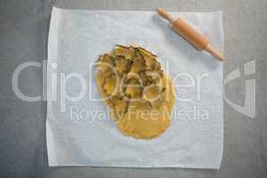 Directly above shot of various shape pastry cutter on rolled dough