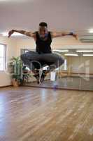 Full length of dancer jumping at studio
