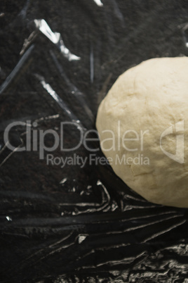 Overhead view of dough on plastic wrap