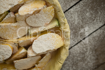 Overhead view of apple slices on pastry dough in baking pan