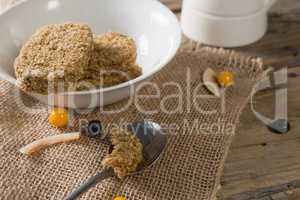 Granola bar and berry fruit on wooden table