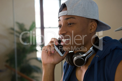 Male dancer talking on mobile phone in studio