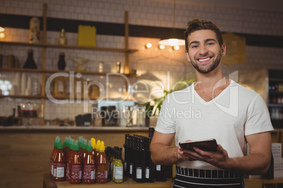 Portrait of waiter with digital tablet in cafe