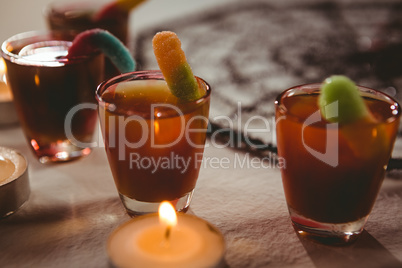 High angle view of candies with drinks and candles