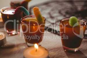 High angle view of candies with drinks and candles