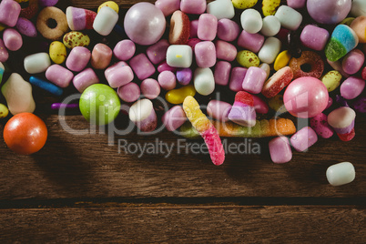 Close up of various candies on wooden table