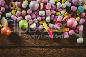 Close up of various candies on wooden table
